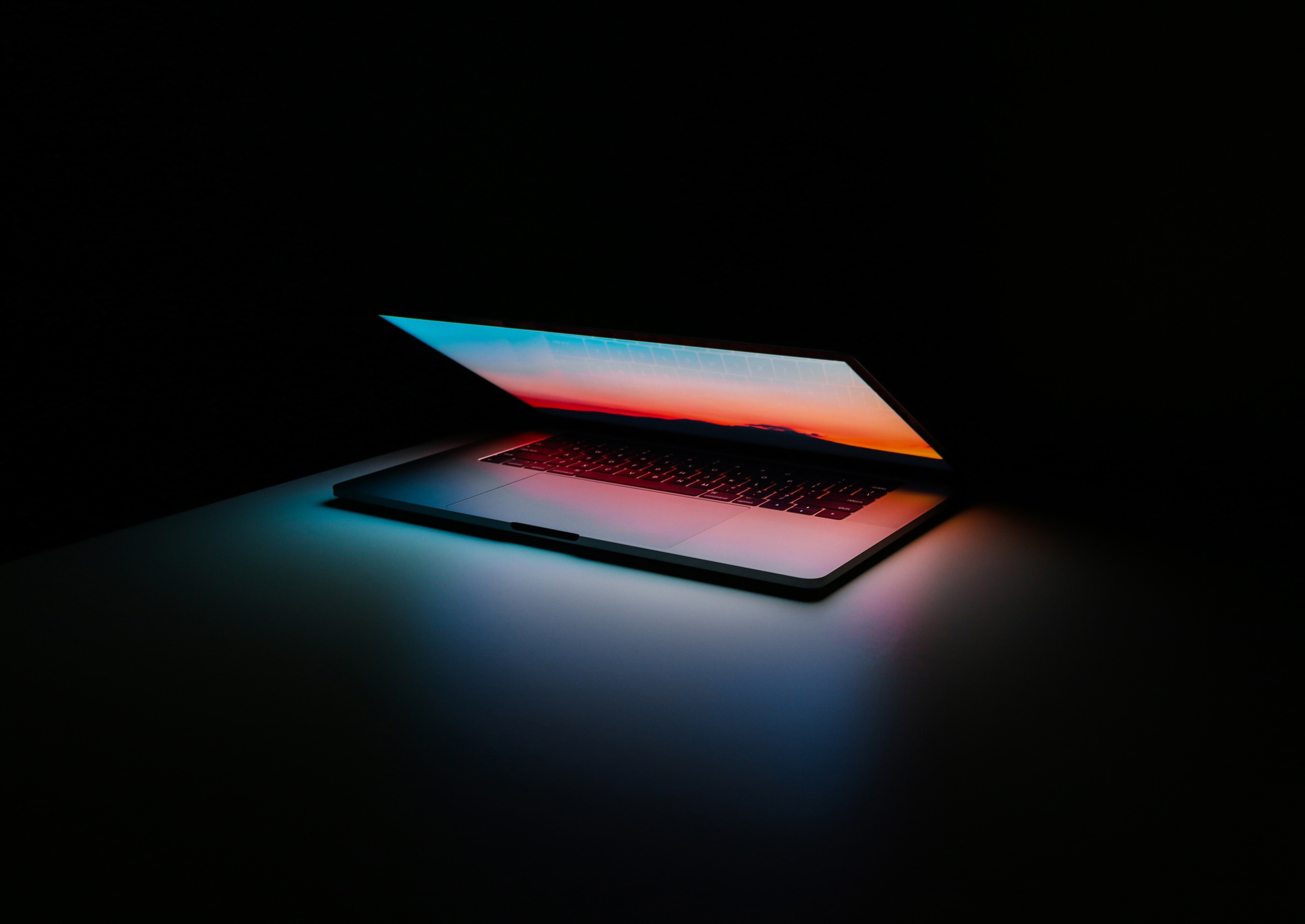 Laptop half open in a dark room